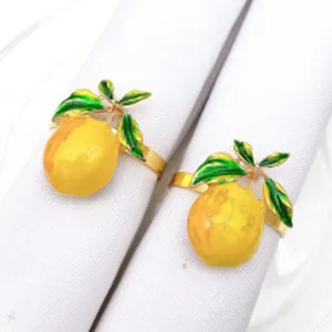 Set di portatovaglioli a forma di limone in metallo dorato con foglie verdi per tavola.