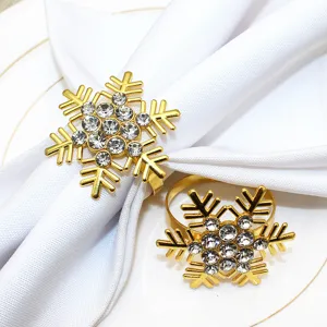 Gold snowflake napkin rings with rhinestones, elegant table decor for Christmas and hotel dinner.
