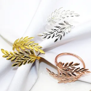 Elegant metal leaf napkin rings set, golden silver and rose gold table decor holders.