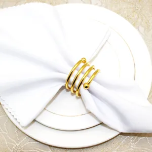 Gold spring napkin ring detail shot displaying the elegant metal spiral structure and double beads.