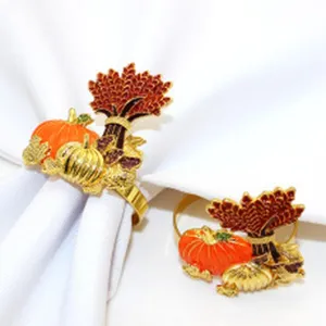 Detail view of the elegant autumn Thanksgiving pumpkin and wheat sheaf metal napkin rings.