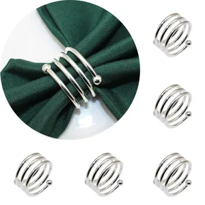 Metal spring napkin ring holder for hotel table decor, silver double bead design detail shot.