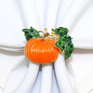 Close-up detail view of the sparkling pumpkin napkin ring with green crystal leaves for autumn.