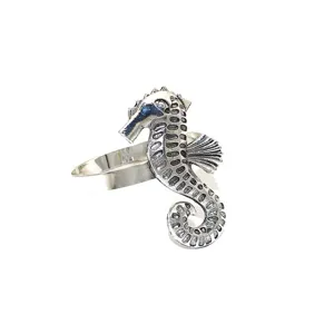 Close-up of vintage silver metal seahorse napkin ring detail, perfect for summer table decor.