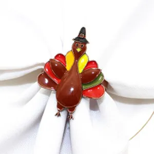 Detail shot of a cute Thanksgiving turkey napkin ring with colorful enamel and a pilgrim hat.