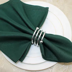 Metal spring napkin ring detail view highlighting polished silver finish and dual ball ends.