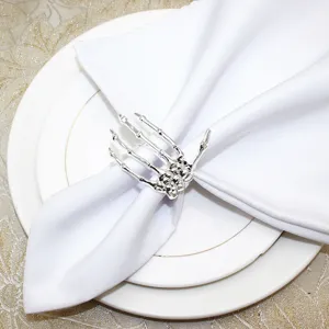 Silver skeleton hand napkin ring for Halloween table decor, gothic dining table accessory.