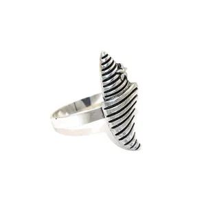Detailed close-up of a vintage silver marine shell napkin ring with starfish, metallic craft.