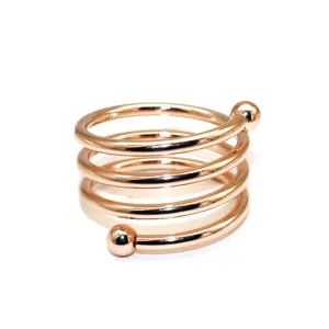 Rose gold metal spiral napkin ring with double ball ends, elegant hotel table decor item.