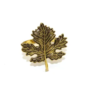 Detail view of antique gold maple leaf napkin ring alloy table decor for Thanksgiving.