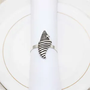 Vintage shell napkin ring detail view, silver metal seaside theme table decor accessory.