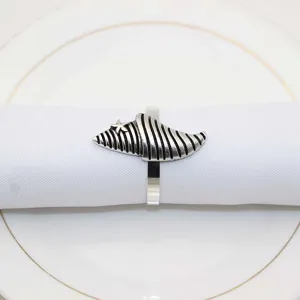 Vintage silver metal seashell napkin ring close-up detail, perfect for table decor.