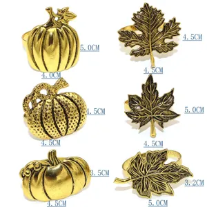 Gold leaf and pumpkin napkin rings set, antique metal napkin holders for Thanksgiving table decor.