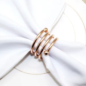 Rose gold metal spring napkin ring detail, elegant table decor for hotel dining and home use.