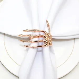Rose gold skeleton hand napkin ring holder for Halloween table decor and party dining settings.