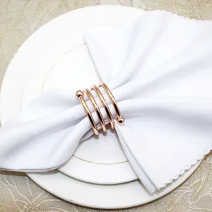 Rose gold spring napkin ring metal holder with double beads for elegant dining table decor.
