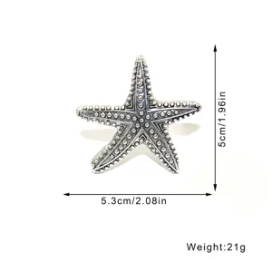 Vintage metal starfish napkin ring holder for summer marine theme table decor and parties.