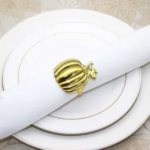 Gold pumpkin napkin ring detail view, elegant table setting decor for Thanksgiving and dinner parties.