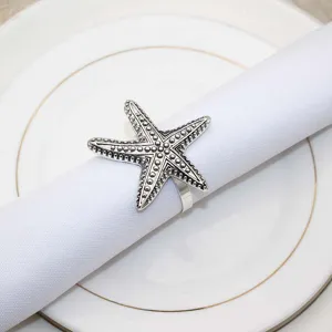 Vintage starfish napkin ring detail view, exquisite silver metal table decor for dining.
