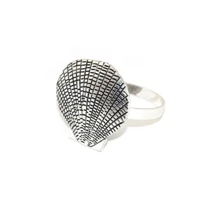 Detailed close-up macro shot of a vintage silver shell-shaped napkin ring for decor.