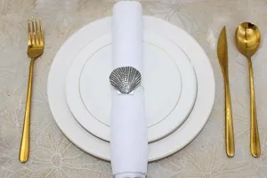 Detail view of vintage metal shell napkin ring, elegant marine style table decor for dining.