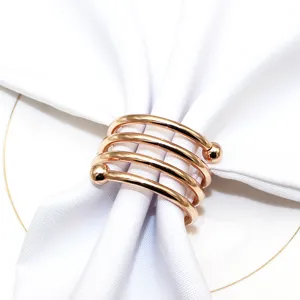 Rose gold metal napkin ring with spring spiral design and double beads, elegant table decor for hotel.