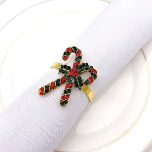 Detailed close-up of Christmas candy cane napkin ring with red green rhinestones alloy.