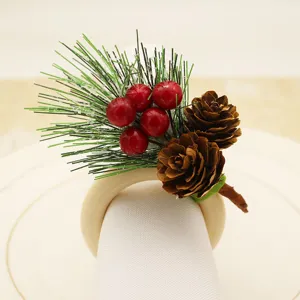 Christmas wooden napkin ring featuring pine needles, red berries and pinecones for holiday decor.