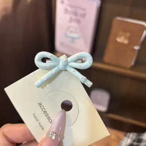 Cute blue bow hairpin detail view, sweet polka dot hair accessory for girls daily wear.