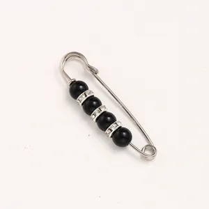 Silver safety pin brooch with black beads and rhinestones for clothing waist adjustment.