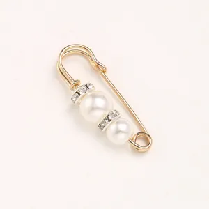 Pearl rhinestone safety pin detail shot showing elegant brooch design for clothing waist adjustment.