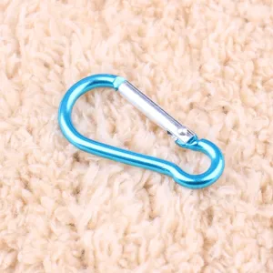 Detailed view of a bright blue aluminum alloy gourd carabiner, showing smooth metallic finish.