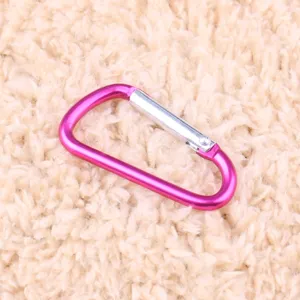 Close-up detail of the pink aluminum alloy D-ring carabiner, ideal for outdoor camping.