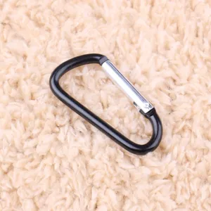 Detail view of the black aluminum alloy D-shaped carabiner buckle, showing fine texture.