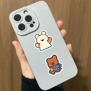 Close-up detail shot of light grey phone case with cute cartoon bear stickers.
