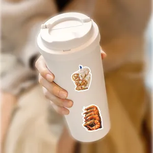 Detailed shot of realistic food stickers applied on a white travel mug, waterproof vinyl.