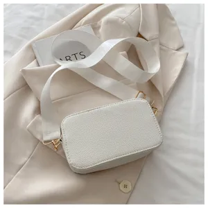Chic white crossbody camera bag with wide strap, trendy minimalist casual shoulder bag for women