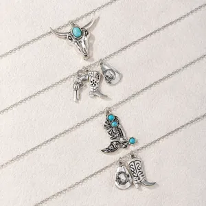 Vintage western cowboy necklace set featuring turquoise cowboy boots and hat pendants for women.
