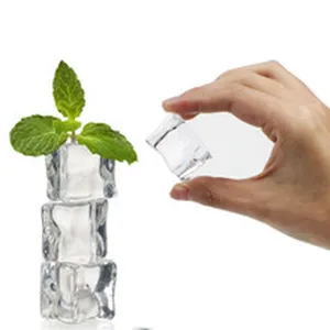 Clear acrylic ice cube props detail shot with green mint leaf decoration for photography display.