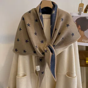 Detailed view of the double-sided star jacquard triangular scarf with delicate hem and cozy fabric.