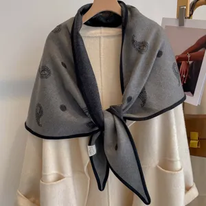 Grey paisley triangular shawl with black border, stylish double-sided commuter accessory.