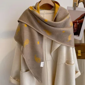 Detail view of the vintage paisley polka dot double-sided triangular shawl in stylish contrast.