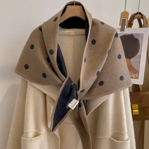 Detail view of double-sided polka dot triangular shawl, thick warm fabric, elegant autumn wear.
