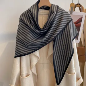Detailed view of the grey and black striped triangle scarf, warm thickened knit design.