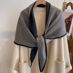 Detail view of the elegant double-sided color block triangle shawl in grey and black.