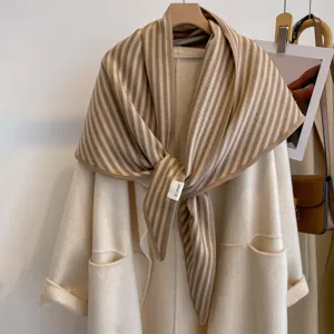Detail view of the retro vertical striped thick triangle shawl layered on white coat.