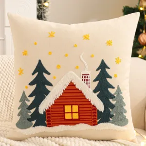 Detailed view of Christmas embroidered canvas pillow cover with cozy winter cabin and tree design.