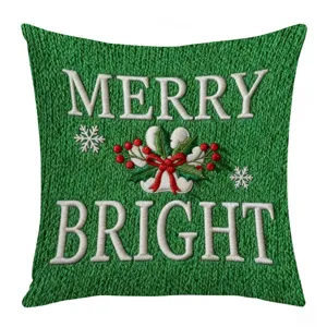 Green knit pillowcase detail featuring white embroidered Merry Bright text and Christmas holly.