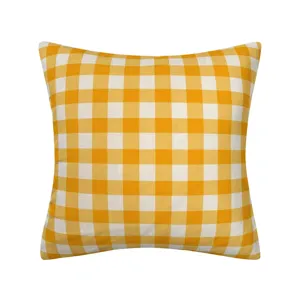 Yellow white gingham pattern pillow cover fabric detail, soft cushion case texture close up.