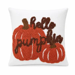 Detail shot of autumn tufted pumpkin cushion cover with textured embroidery and cozy style.